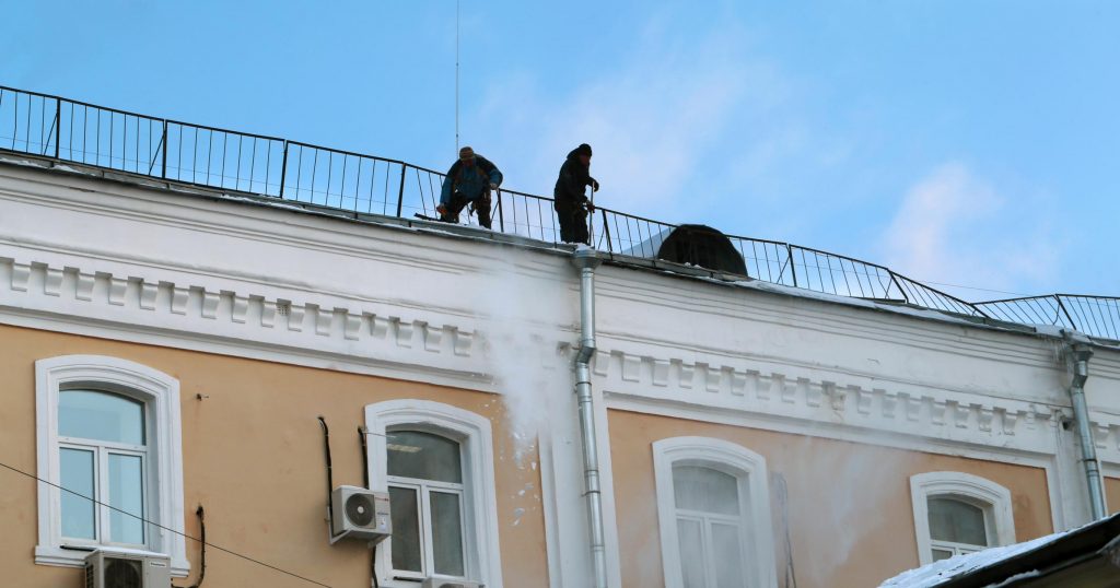 men repairing the commerial roof